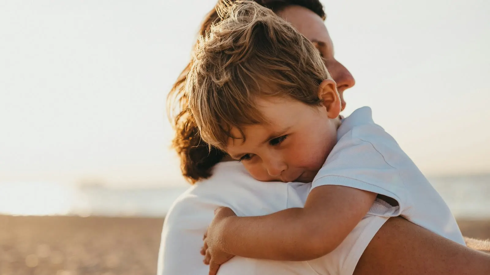 A caregiver holding and comforting a child